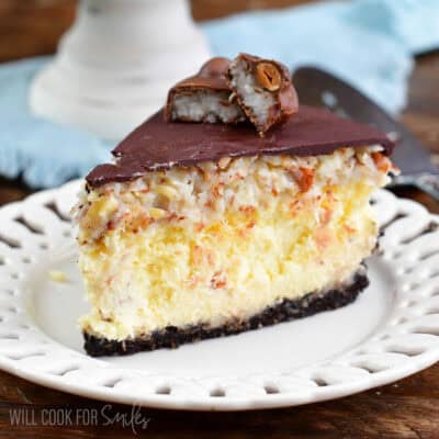 a slice of Almond Joy cheesecake on a white plate.