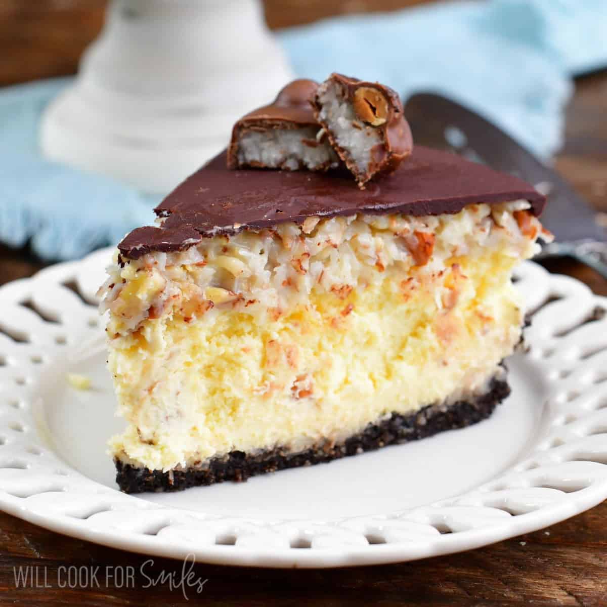 a slice of Almond Joy cheesecake on a white plate.