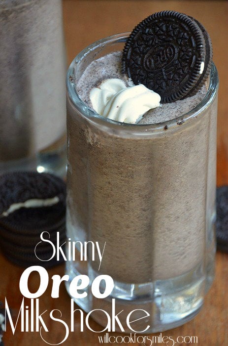 oreo milkshake with a oreo on top and whipped cream in a glass mug 