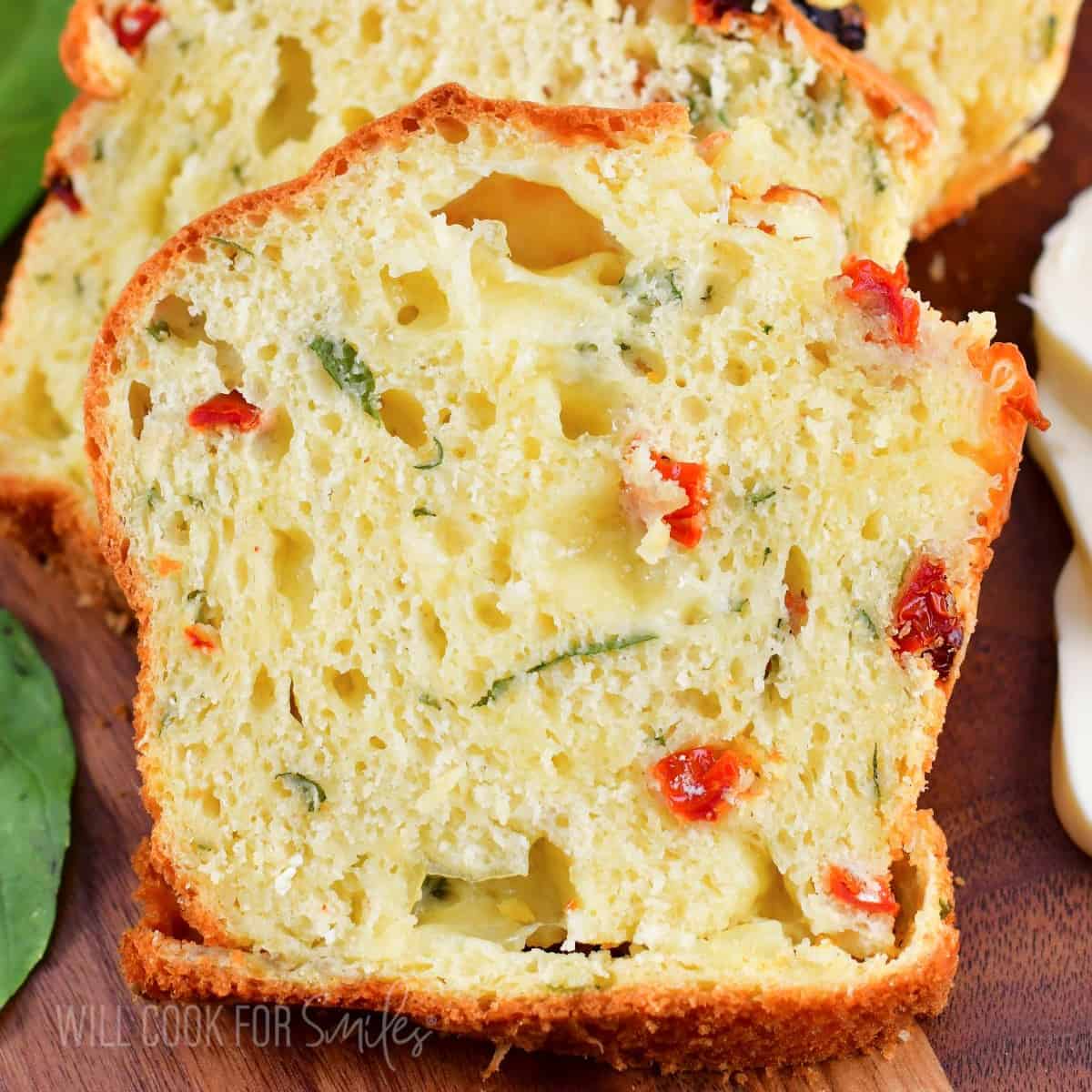 one slice of caprese bread on a cutting board with some on background.