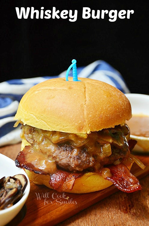 Whiskey burger with a bun on a wood cutting board 