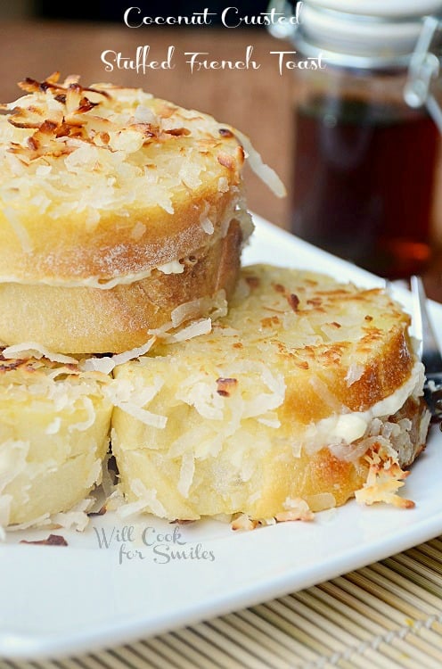 Coconut Stuffed French Toast stacked on a white plate 