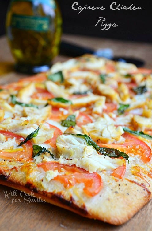 Caprese Chicken Pizza on a cutting board 