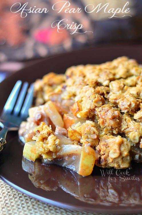 Asian Pear Crisp on a brown plate with a fork to the left 