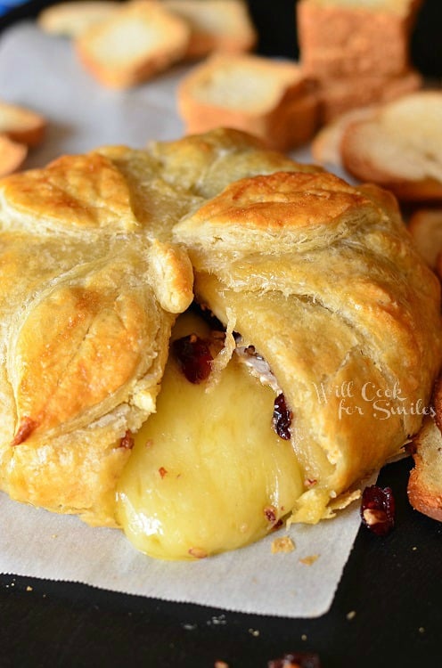 Cranberry Maple Baked Brie with a slice taken out 