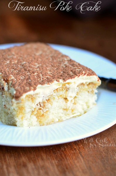 Tiramisu poke cake slice on a white plate 