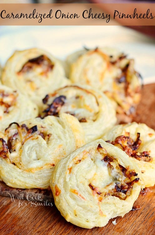 Caramelized Onion Cheesy Pinwheels on a wood cutting board 