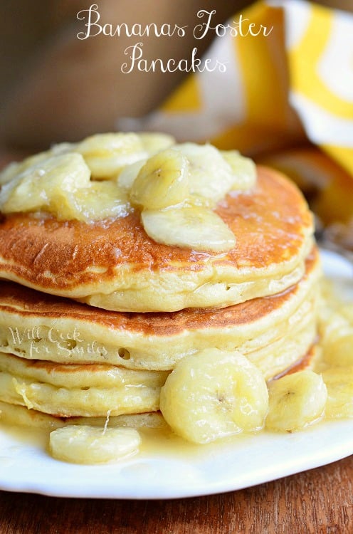 Bananas Foster Pancakes on a plate with banana's on it sitting on a table 