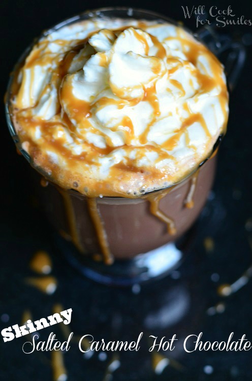 Caramel Hot Chocolate with whip cream and caramel sauce on top and caramel sauce coming over the sides 