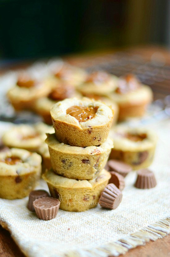 Peanut Butter Cookie stacked up on a placemat with mini reeses around it 