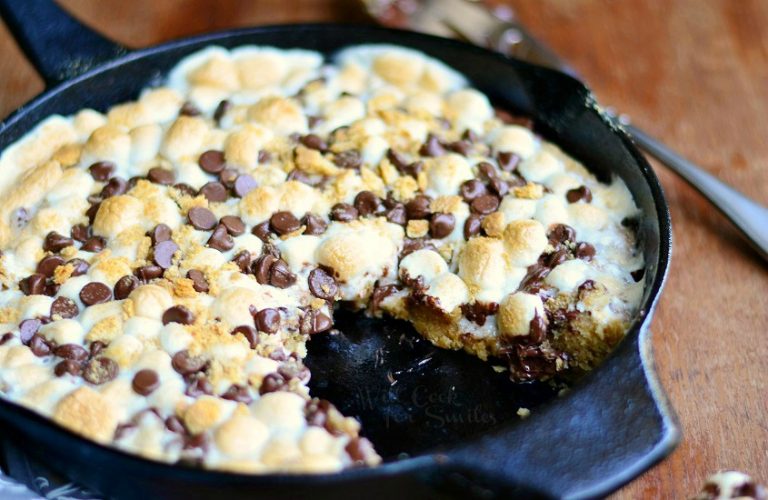 close up view of Smores skillet cookie on wood table with pie cutter to the right resting on table