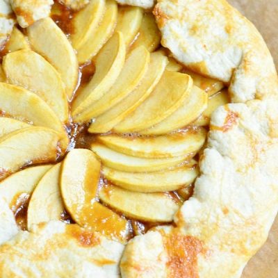 view fro above of caramel apple galette on wax paper on wooden table