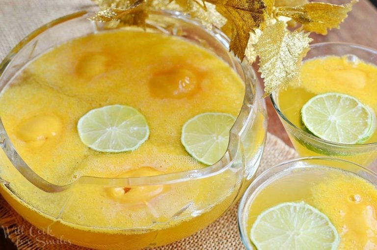 view from above of Decorative wine glass filled with champagne sorbet punch on a burlap placemat with a bowl filled with punch to the left