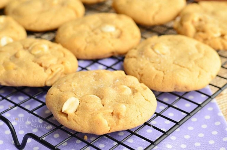 Sweet and salty white chocolate chip peanut butter cookies on a cooling rack on top of blue cloth