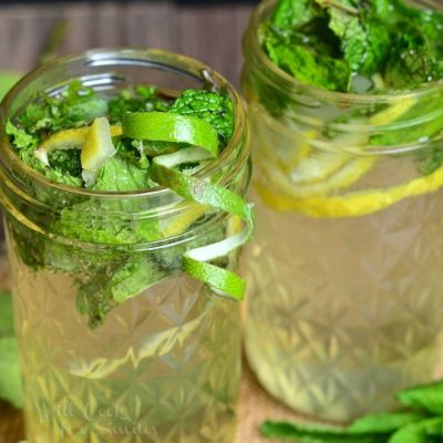 Mason jar filled with Lemon Lime Mojito with mint and lime skin garnish with a second jar filled in the background