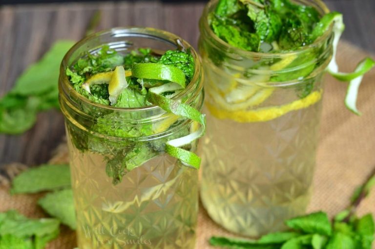 Mason jar filled with Lemon Lime Mojito with mint and lime skin garnish with a second jar filled in the background