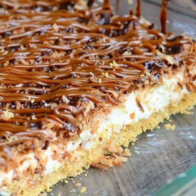 Glass baking dish filled with no bake samoas cheesecake bars