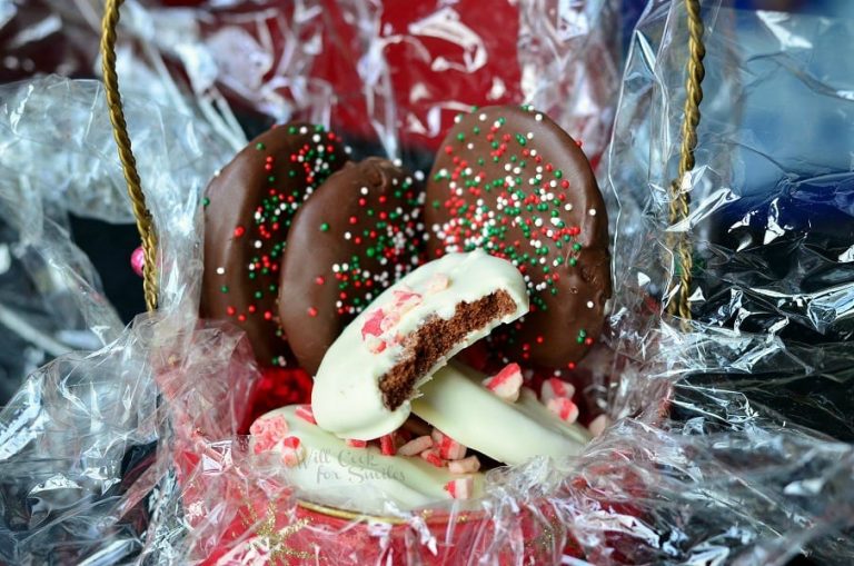 pile of chocolate covered peppermint crunchy cookies filling up a gift bucket with plastic wraping and filler