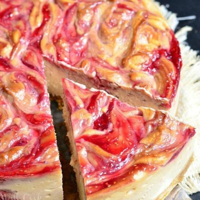 view from above of peanut butter and jelly cheesecake while one slice is being removed