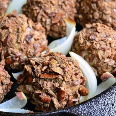 black skillet with pretzel crusted paresan turkey meatballs as viewed close up