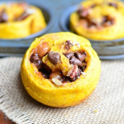 3 pumpkin turtle rolls on a wooden table