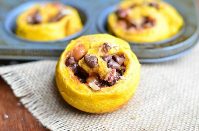 3 pumpkin turtle rolls on a wooden table