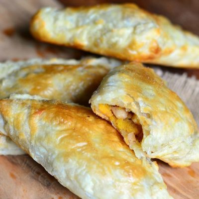 4 spiced pumpkin apple pear turnovers on a wooden cutting board