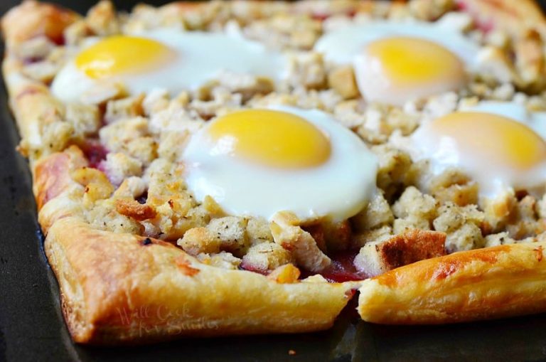 Close up view of Thanksgiving leftover tart featuring turkey stuffing, egg and cranberry