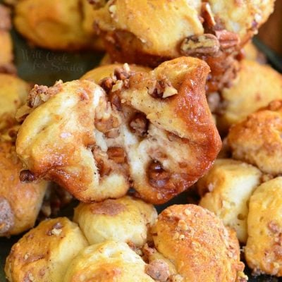 butter pecan pull apart biscuits stacked up on a baking sheet,