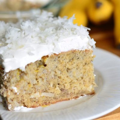 1 slice of lemon coconut banana cake on a white plate as viewed close up