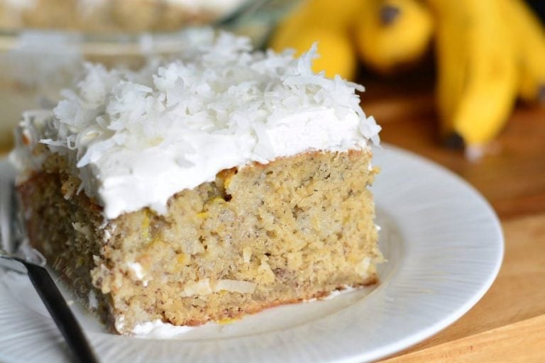 1 slice of lemon coconut banana cake on a white plate as viewed close up