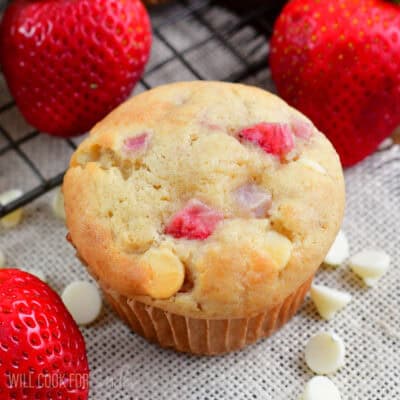 one strawberry white chocolate chip muffin surrounded by strawberries.