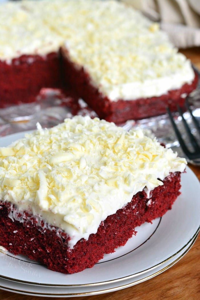 Red Velvet Brownies. Beautiful, chewy red velvet brownies topped with white chocolate cream cheese frosting and white chocolate shavings. #brownies #dessert #redvelvet #frosting #creamcheesefrosting #whitechocolate