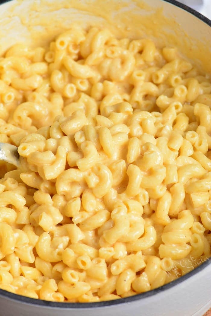 Mac and Cheese Recipe in a pot with a serving spoon 