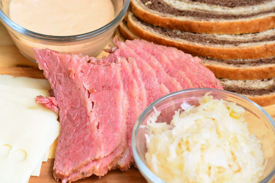 ingredients for ruben sandwich on cutting board 