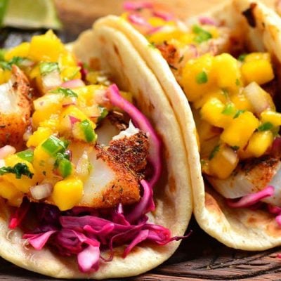 two soft tortillas with flaked blackened fish, cabbage, and mango salsa.