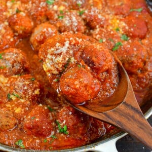 squared image of closeup meatballs in a wooden spoon