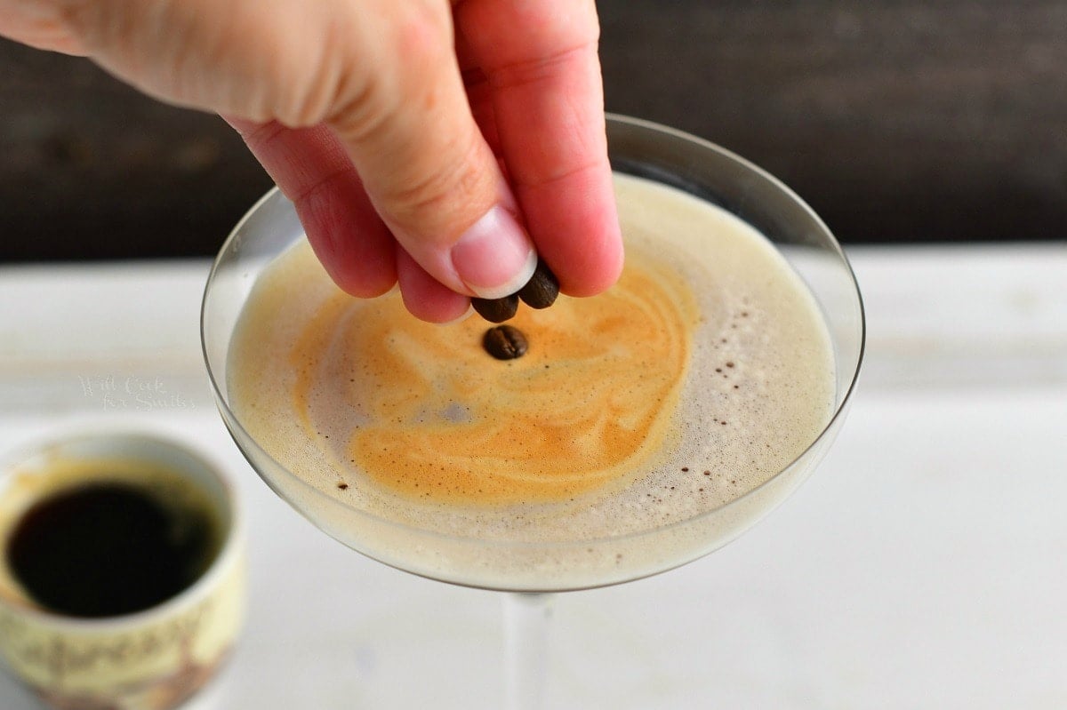 garnishing the cocktail with coffee beans