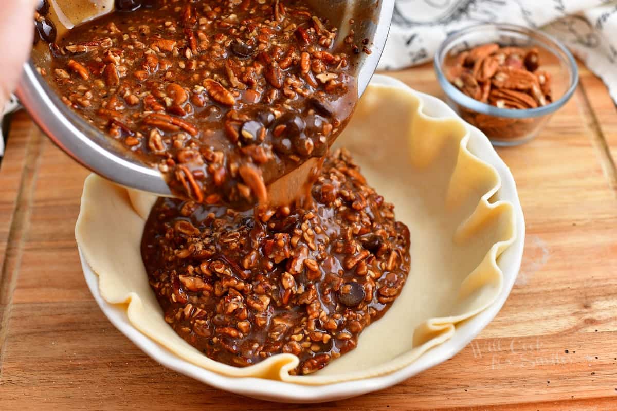 pouring chocolate pie filling into pie crust