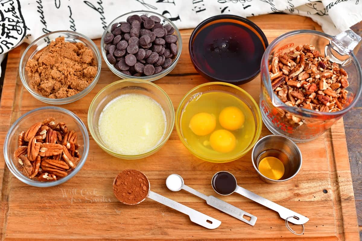 chocolate pecan pie recipe ingredients in prep bowls on wood cutting board