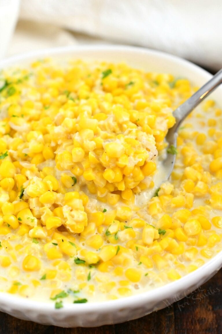 overhead closeup: spoonful of creamed corn in a bowl