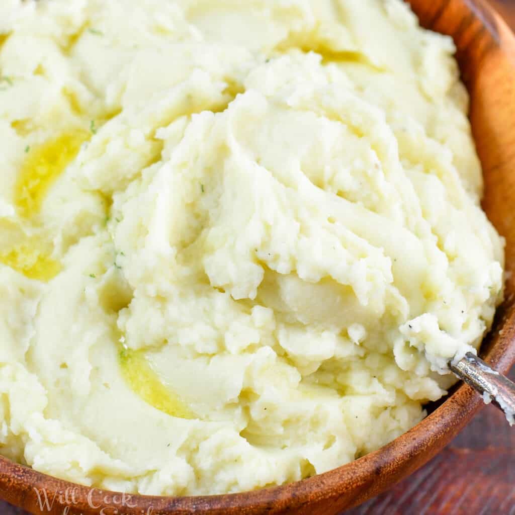 closeup of scooping out some mashed potatoes.