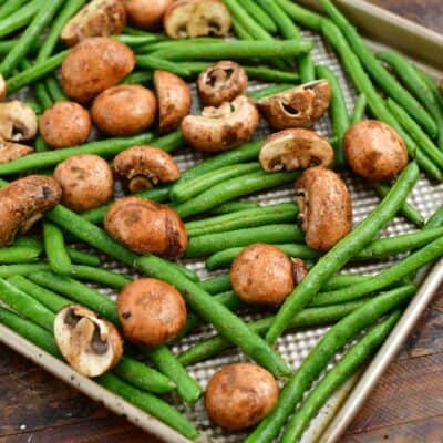 raw mushrooms and fresh green beans for making a roasted vegetables recipe