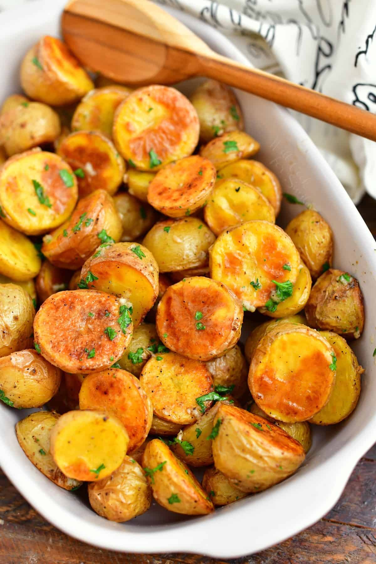 roasted potato side dish in white serving bowl