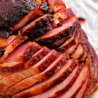 slices of glazed ham on white platter