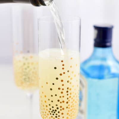 pouring champagne into a glass for a champagne cocktail