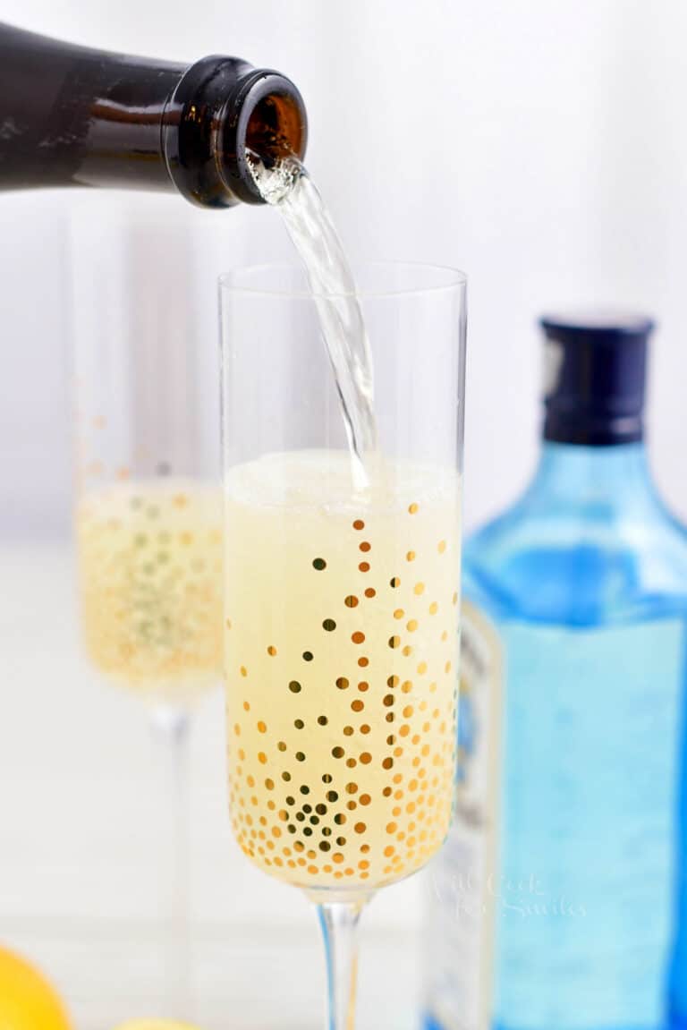 pouring champagne into a glass for a champagne cocktail