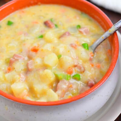 overhead image: spoon in orange bowl of creamy ham chowder