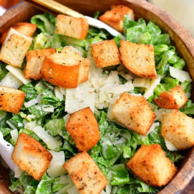 overhead image: wooden bowl of green salad with homemade croutons