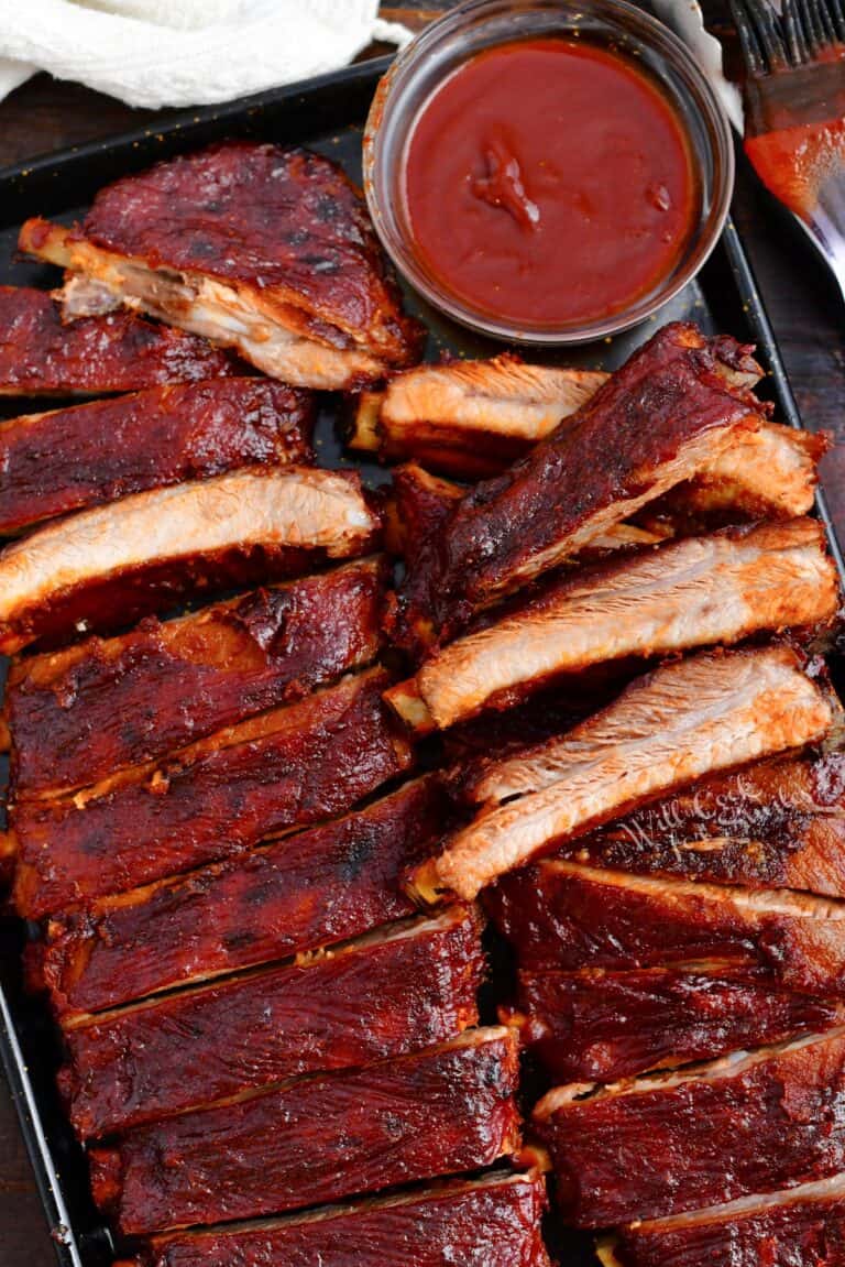 oven baked ribs with side of bbq sauce